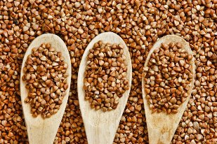 Buckwheat in wooden spoons